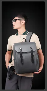 Detail view of dark grey matte leather backpack with decorative metal stud straps