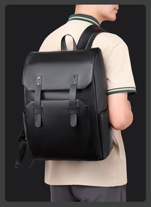 Side view of black matte leather backpack with flap cover and metal stud details