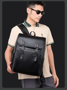 Close-up of stylish black leather backpack with flap cover and decorative buckles