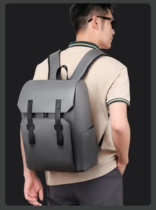 Side view of gray minimalist backpack with matte waterproof fabric and black straps