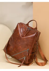 Detail of dark brown checkerboard backpack with premium leather texture and zipper pockets