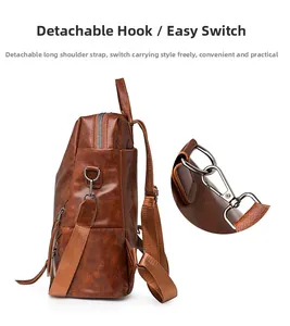 Detail of detachable metal hooks and adjustable shoulder straps on brown checkerboard backpack
