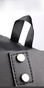 Close-up of black lychee grain leather backpack with silver metal studs and nylon strap