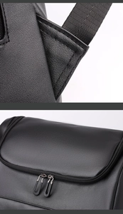 Detail of matte black leather backpack showing durable stitching and dual metal zippers