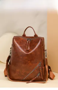 Detailed macro view of the vintage brown PU leather backpack with a side zipper pocket