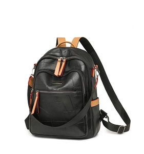 Detail of black and brown PU leather backpack with geometric patchwork and multi-zipper pockets