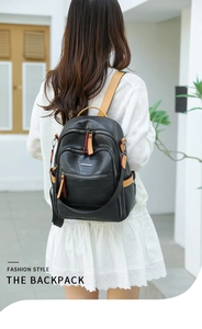 Close-up of stylish black PU leather backpack with geometric texture and yellow zipper detail