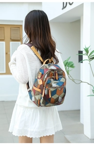 Close-up of colorful geometric patchwork PU leather backpack with lychee grain texture