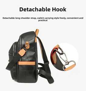 Detail of detachable metal hook on black and tan leather backpack with strap