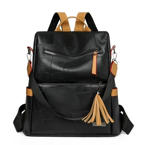 Fashionable black faux leather backpack with contrast stitching and yellow tassel accent