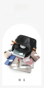 Spacious interior of black PU leather backpack showing storage for tablet and daily items
