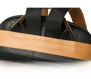 Detailed macro view of reinforced stitching and brown leather texture on a woman's backpack
