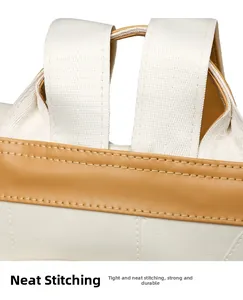 Close-up of precise stitching on a beige PU leather backpack with durable fabric straps