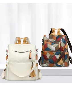 Detail of PU leather backpacks showing tassels and geometric patterns on white surface
