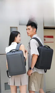 Detail view of business backpack showing external USB charging port and waterproof material