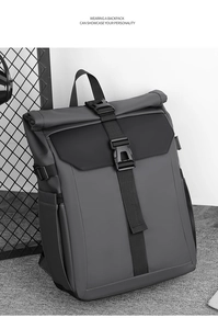 Detail of grey and black roll-top backpack with tactical buckles and durable fabric