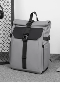 Detail of the roll-top closure and quick-release buckle on gray waterproof backpack