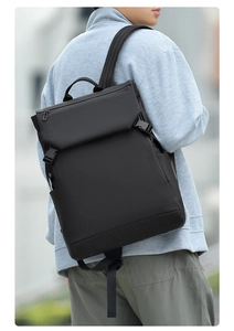 Detail of waterproof black casual laptop backpack with padded straps on man's back