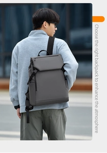 Outdoor view of a dark grey laptop backpack with wide adjustable straps on a male model
