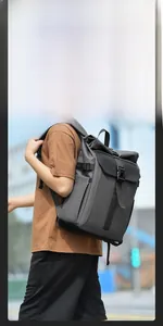 Detail view of large capacity dark grey roll-top backpack with durable side pockets