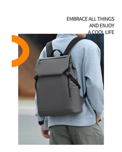 Detail of dark grey laptop backpack with buckle flap and wide shoulder straps