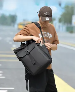Close-up of a black waterproof backpack featuring a buckle closure and side water bottle pocket