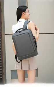 Detail of grey business backpack showing USB charging port and ergonomic back padding