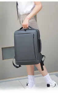Business laptop backpack in dark grey with side handle shown in street style view