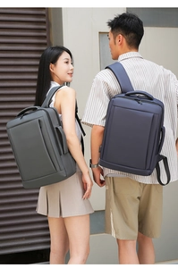 Detail of couple wearing gray and navy business backpacks with USB port and ergonomic straps