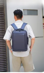 Detail view of large business backpack in navy blue carried by a male model