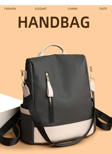 Detailed close-up of fashion handbag with black woven texture and cream trim details