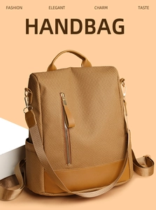 Detailed view of brown woven leather backpack with vertical zipper and side pocket texture