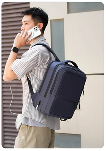 Detail of navy blue business backpack featuring an integrated external USB charging port