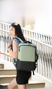 Outdoor commute view of olive green and black dual-color business laptop backpack
