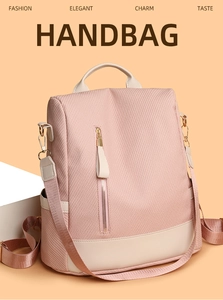 Detail of pink waffle texture fabric and cream leather backpack with gold zippers