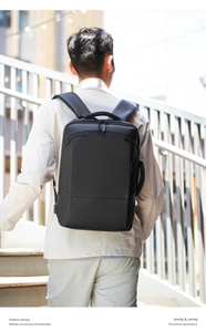 Outdoor shot of the padded shoulder straps and USB charging port on the black laptop backpack