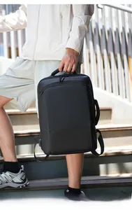 Detail of a minimalist black business laptop backpack with built-in external USB charging port
