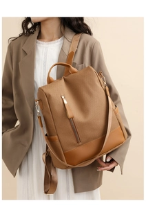 Brown woven leather backpack detailed with side pockets and smooth leather trim