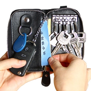 Detail view of genuine leather car key bag with metal hooks and card slot holder