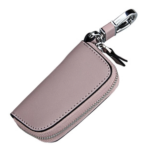 Detail of pink leather car key case featuring secure zipper and metal swivel hook clasp
