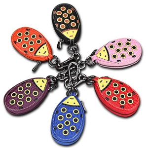Detailed view of ladybug-shaped leather key pouches in six vibrant colors with metal clips