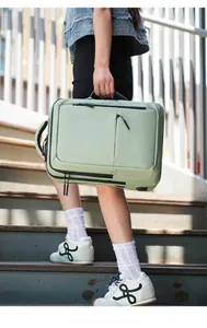 Action shot of a mint green waterproof laptop backpack with multiple zipper pockets
