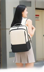 Close-up of beige and black contrast laptop backpack worn by a model in a city street