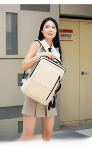 Detail view of cream business laptop backpack with black zippers and multi-layer pockets