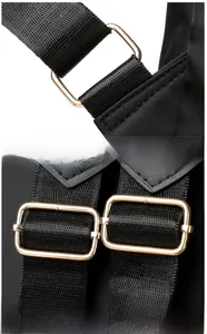 Close-up of adjustable nylon shoulder strap with polished gold-tone metal buckles