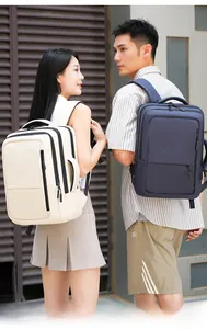 Outdoor shot of cream and navy waterproof nylon backpacks with side handles for travel
