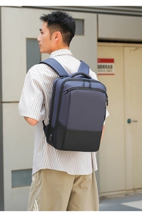 Close-up of a blue and black business backpack featuring an external USB charging port