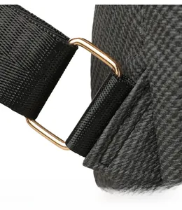 Detail of golden metal buckle connecting black nylon strap to grey woven fabric bag