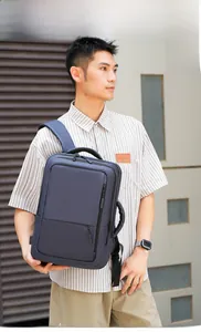 Detail of blue business laptop backpack showing multi-pocket design and external USB port