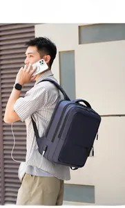 Deep blue multi-layer laptop backpack with external USB port on side view detail